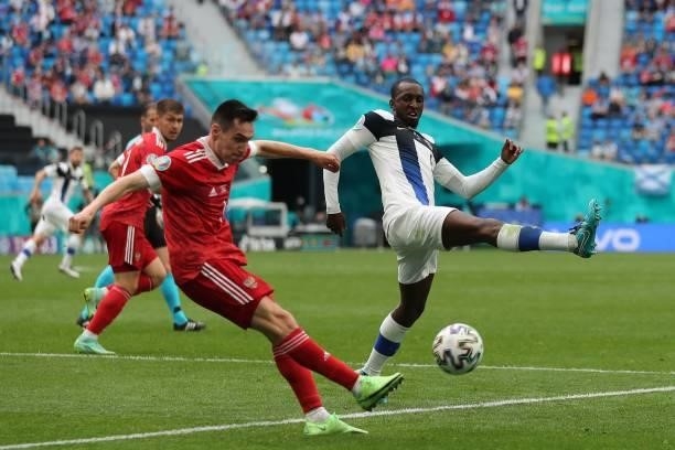 Russia's midfielder Magomed Ozdoev shoots past Finland's midfielder Glen Kamara during the UEFA EURO 2020 Group B football match between Finland and...