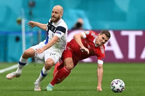 Finland's forward Teemu Pukki and Russia's midfielder Roman Zobnin vie during the UEFA EURO 2020 Group B football match between Finland and Russia at...