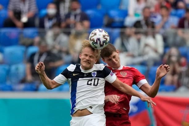 Finland's forward Joel Pohjanpalo and Finland's defender Daniel O'Shaughnessy vie during the UEFA EURO 2020 Group B football match between Finland...