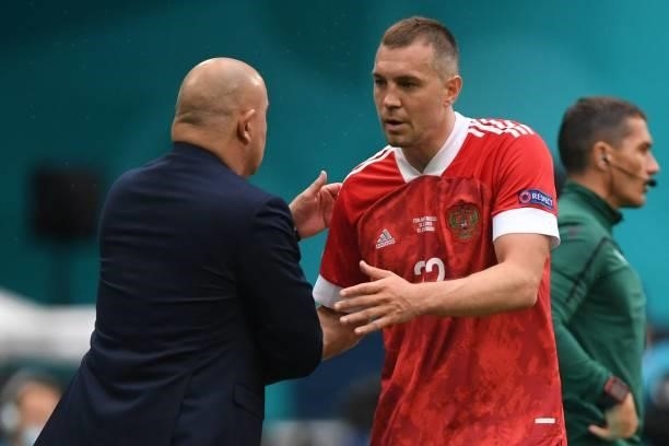 Russia's coach Stanislav Cherchesov speaks with Russia's forward Artem Dzyuba during the UEFA EURO 2020 Group B football match between Finland and...