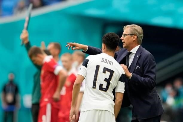 Finland's coach Markku Kanerva speaks to Finland's midfielder Pyry Soiri during the UEFA EURO 2020 Group B football match between Finland and Russia...