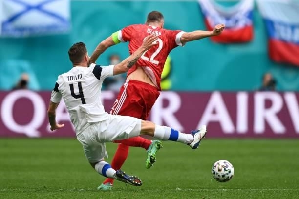 Finland's defender Joona Toivio goes down after a challange by Russia's forward Artem Dzyuba during the UEFA EURO 2020 Group B football match between...