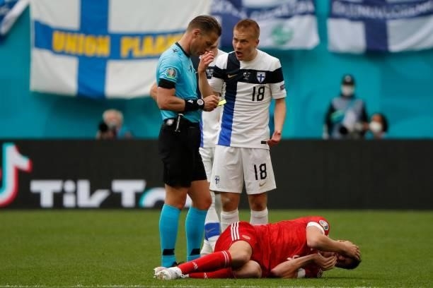 Finland's defender Jere Uronen speaks with Dutch referee Danny Makkelie during the UEFA EURO 2020 Group B football match between Finland and Russia...