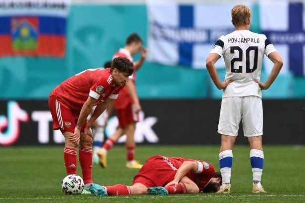 Russia's defender Georgiy Dzhikiya is injured during the UEFA EURO 2020 Group B football match between Finland and Russia at the Saint Petersburg...