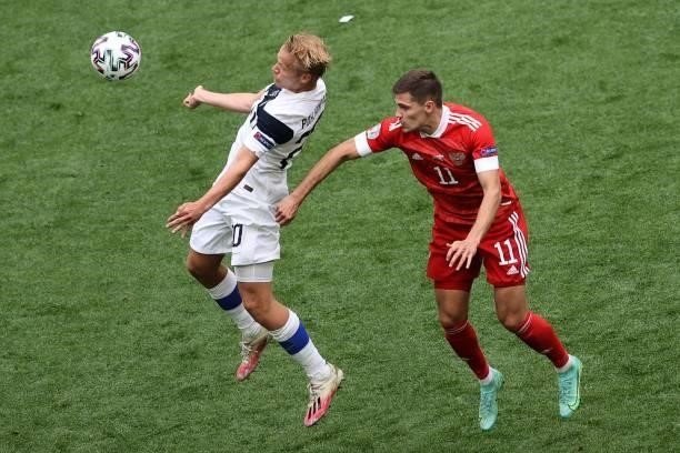 Finland's forward Joel Pohjanpalo and Russia's midfielder Roman Zobnin vie during the UEFA EURO 2020 Group B football match between Finland and...