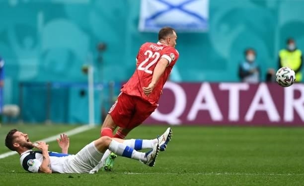 Finland's defender Joona Toivio goes down after a challange by Russia's forward Artem Dzyuba during the UEFA EURO 2020 Group B football match between...