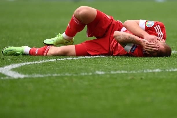 Russia's midfielder Dmitriy Barinov reacts injured during the UEFA EURO 2020 Group B football match between Finland and Russia at the Saint...