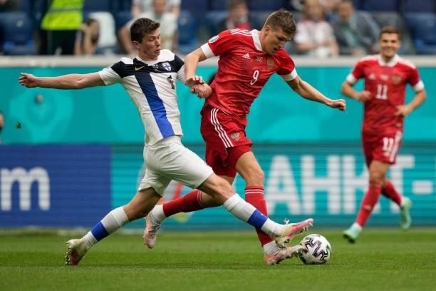 Finland's defender Daniel O'Shaughnessy and Russia's forward Alexander Sobolev vie during the UEFA EURO 2020 Group B football match between Finland...