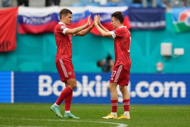 Russia's midfielder Roman Zobnin and Russia's midfielder Aleksandr Golovin celebrate after the final whistle of the UEFA EURO 2020 Group B football...