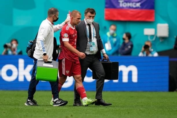Russia's midfielder Dmitriy Barinov receives medical attention during the UEFA EURO 2020 Group B football match between Finland and Russia at the...
