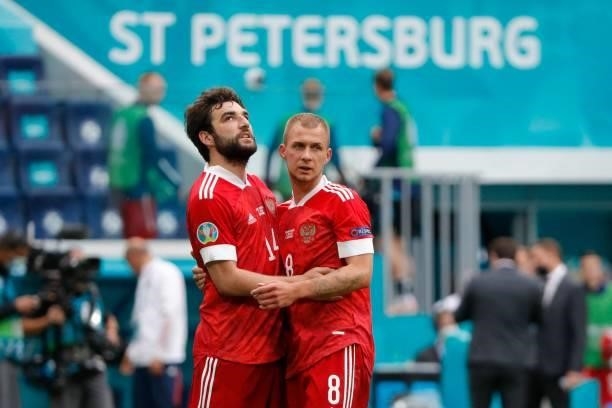 Russia's midfielder Dmitriy Barinov and Russia's defender Georgiy Dzhikiya celebrate after the final whistle of the UEFA EURO 2020 Group B football...