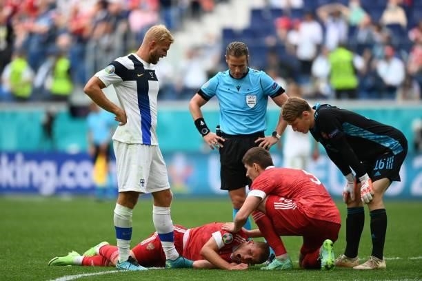 Russia's midfielder Dmitriy Barinov is injured during the UEFA EURO 2020 Group B football match between Finland and Russia at the Saint Petersburg...