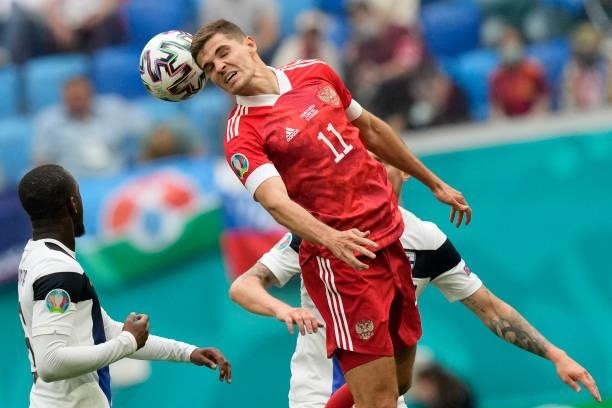 Russia's midfielder Roman Zobnin heads the ball during the UEFA EURO 2020 Group B football match between Finland and Russia at the Saint Petersburg...