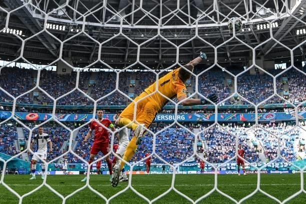 Finland's goalkeeper Lucas Hradecky concedes the opening goal goal shot by Russia's forward Aleksey Miranchuk during the UEFA EURO 2020 Group B...