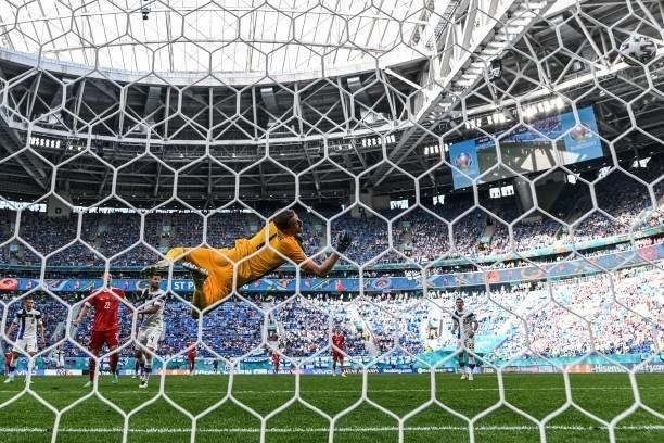 Finland's goalkeeper Lucas Hradecky concedes the opening goal goal shot by Russia's forward Aleksey Miranchuk during the UEFA EURO 2020 Group B...