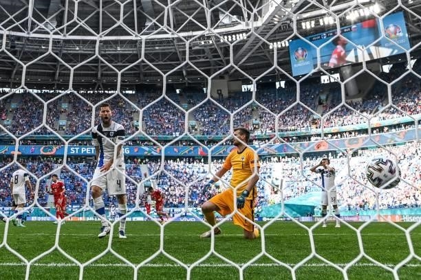 Finland's goalkeeper Lucas Hradecky and Finland's Joona Toivio react after Russia's forward Aleksey Miranchuk scored the opening goal during the UEFA...