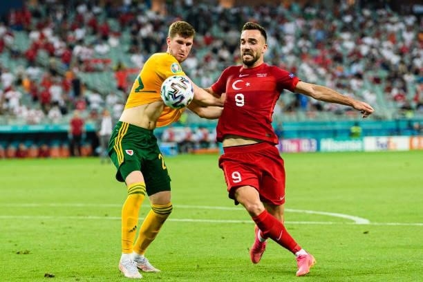 Christopher Mepham of Wales fights for the ball with Kenan Karaman of Turkey during the UEFA Euro 2020 Championship Group A match between Turkey and...