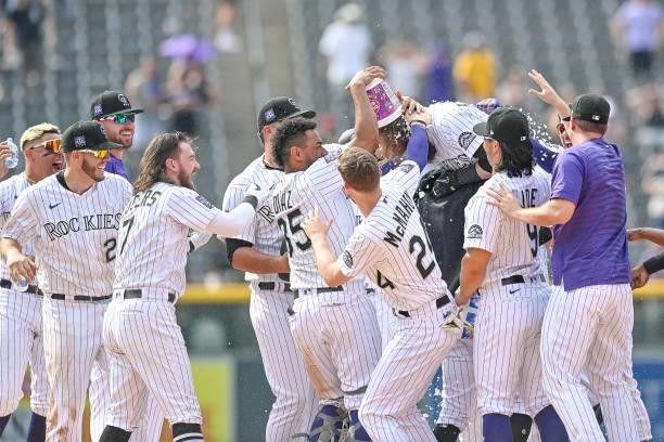 Charlie Blackmon of the Colorado Rockies celebrates with teammates after hitting a ninth inning walk off RBI single against the San Diego Padres at...