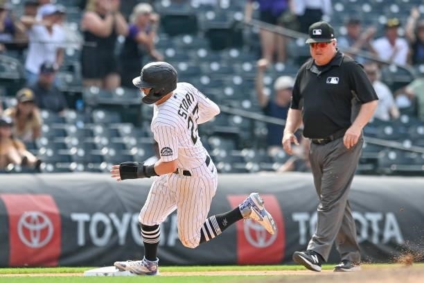 Trevor Story of the Colorado Rockies rounds third base before scoring the winning run against the San Diego Padres in the ninth inning of a game at...