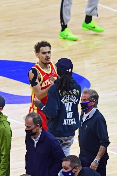 Trae Young of the Atlanta Hawks high fives artist Quavo after the game against the Philadelphia 76ers in game 5 of the conference semifinals on June...