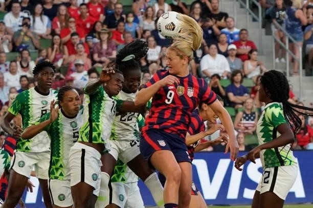 Lindsey Horan of the United States heads the ball against Chidinma Okeke and Michelle Alozie of Nigeria during the first half of their WNT Summer...