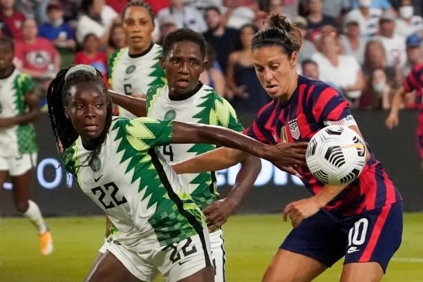 Carli Lloyd of the United States competes for the ball against Michelle Alozie of Nigeria during the first half of their WNT Summer Series game at Q2...