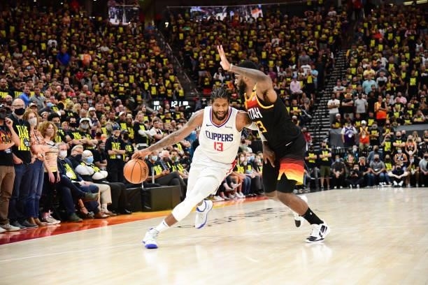 Paul George of the LA Clippers handles the ball as Royce O'Neale of the Utah Jazz plays defense during the game during Round 2, Game 5 of the 2021...