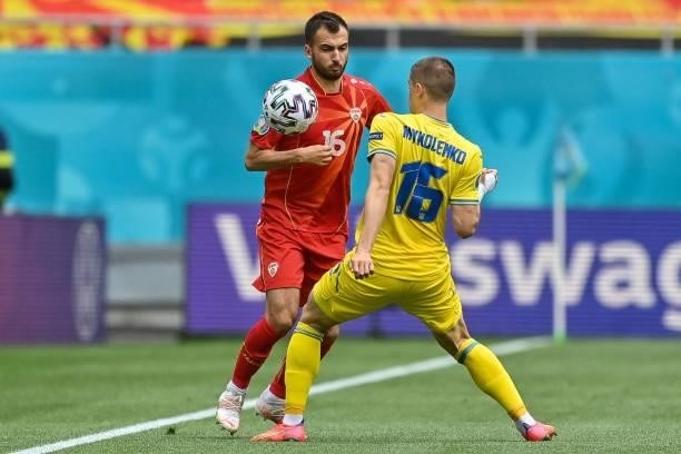 North Macedonia's midfielder Boban Nikolov fights for the ball with Ukraine's defender Vitaliy Mykolenko during the UEFA EURO 2020 Group C football...