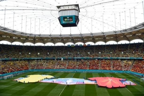 Volunteers displays banners depicting the team jersey's on the pitch prior to the UEFA EURO 2020 Group C football match between Ukraine and North...