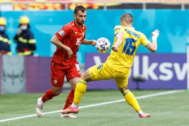 Boban Nikolov of North Macedonia and Vitaliy Mykolenko of Ukraine battle for the ball during the UEFA Euro 2020 Championship Group C match between...