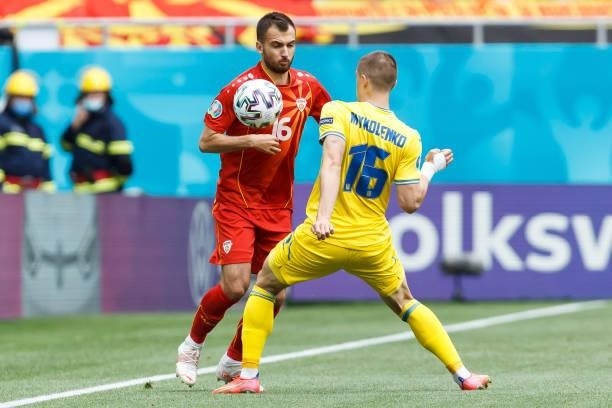 Boban Nikolov of North Macedonia and Vitaliy Mykolenko of Ukraine battle for the ball during the UEFA Euro 2020 Championship Group C match between...