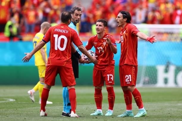 North Macedonia's forward Goran Pandev , North Macedonia's midfielder Enis Bardhi and North Macedonia's midfielder Eljif Elmas react to Argentinian...