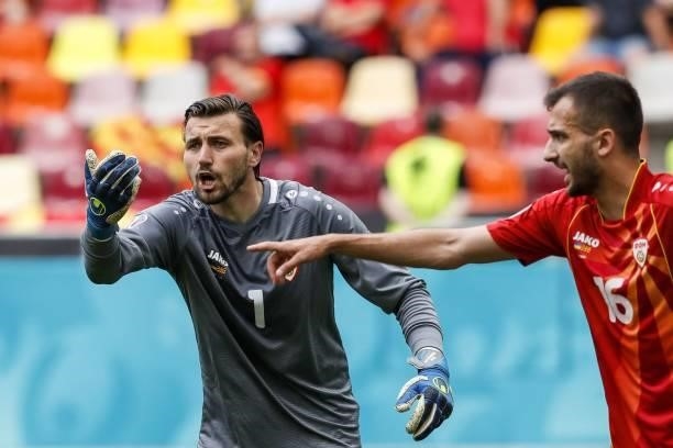 North Macedonia's goalkeeper Stole Dimitrievski gestures to teammates during the UEFA EURO 2020 Group C football match between Ukraine and North...