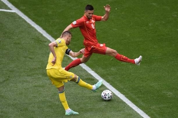 Ukraine's forward Andriy Yarmolenko shoots the ball as North Macedonia's defender Visar Musliu goes to block it during the UEFA EURO 2020 Group C...