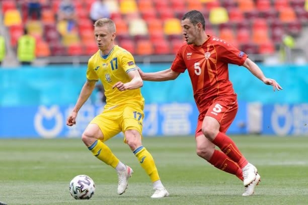 Oleksandr Zinchenko of Ukraine and Arijan Ademi of North Macedonia battle for the ball during the UEFA Euro 2020 Championship Group C match between...