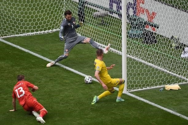 Ukraine's forward Andriy Yarmolenko scores the opening goal past North Macedonia's goalkeeper Stole Dimitrievski during the UEFA EURO 2020 Group C...
