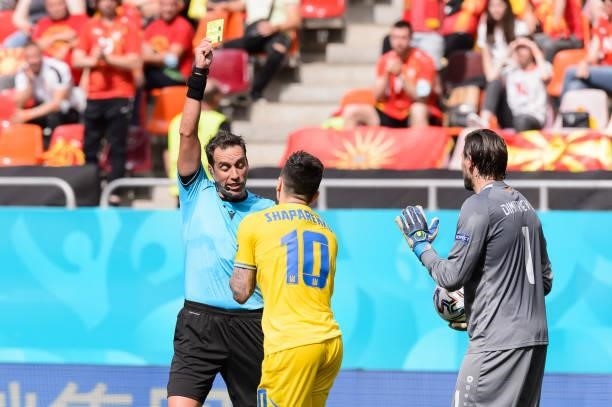 Mykola Shaparenko of Ukraine and referee Fernando Andres Rapallini shows the yellow card during the UEFA Euro 2020 Championship Group C match between...