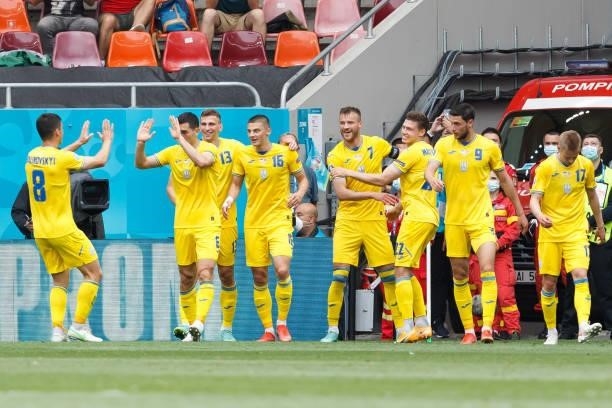Andriy Yarmolenko of Ukraine celebrates after scoring his team's first goal with teammates during the UEFA Euro 2020 Championship Group C match...
