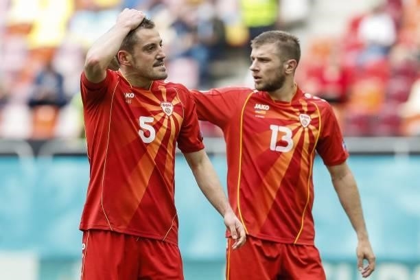 North Macedonia's midfielder Arijan Ademi reacts with North Macedonia's defender Stefan Ristovski after missing a goal opportunity during the UEFA...