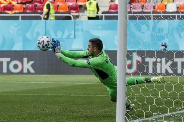Ukraine's goalkeeper Georgiy Bushchan deflects a penalty during the UEFA EURO 2020 Group C football match between Ukraine and North Macedonia at the...