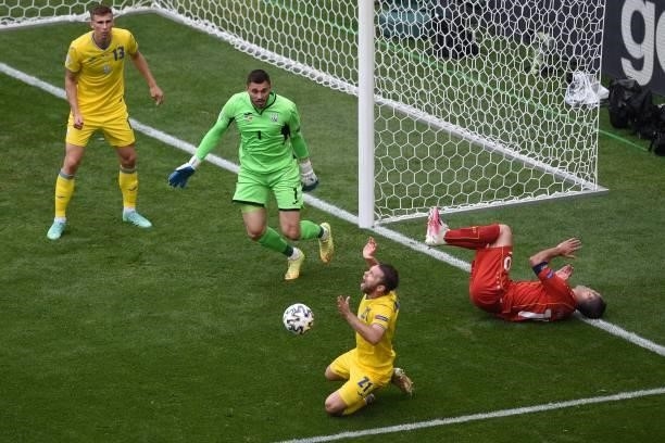 Ukraine's defender Oleksandr Karavaev fouls North Macedonia's forward Goran Pandev and concedes a penalty during the UEFA EURO 2020 Group C football...
