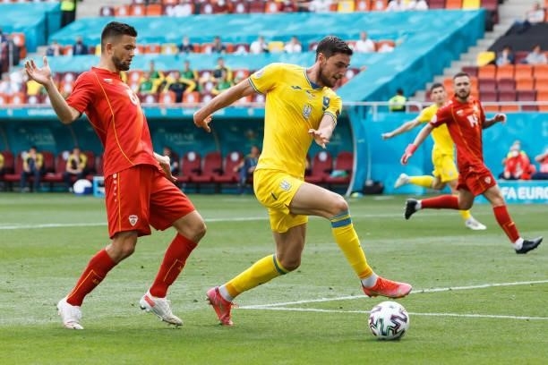 Egzjan Alioski of North Macedonia and Roman Yaremchuk of Ukraine battle for the ball during the UEFA Euro 2020 Championship Group C match between...