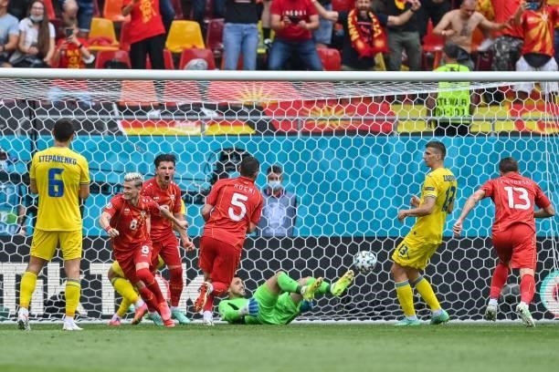 North Macedonia's defender Ezgjan Alioski scores hi steam's first goal during the UEFA EURO 2020 Group C football match between Ukraine and North...
