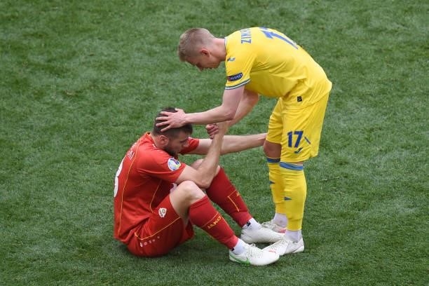 Ukraine's defender Oleksandr Zinchenko and North Macedonia's defender Ezgjan Alioski react after Ukraine won the UEFA EURO 2020 Group C football...