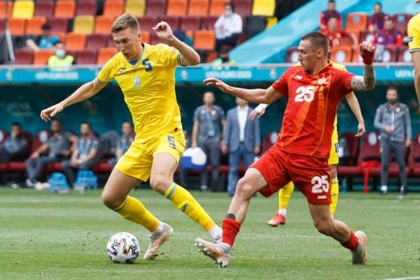 Sergiy Sydorchuk of Ukraine and Darko Churlinov of North Macedonia battle for the ball during the UEFA Euro 2020 Championship Group C match between...