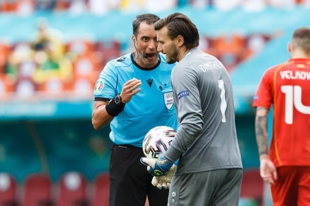 Referee Fernando Andres Rapallini and Stole Dimitrievski of North Macedonia speak during the UEFA Euro 2020 Championship Group C match between...