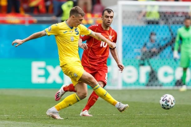 Sergiy Sydorchuk of Ukraine and Goran Pandev of North Macedonia battle for the ball during the UEFA Euro 2020 Championship Group C match between...