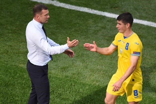 Ukraine's midfielder Ruslan Malinovskyi reacts with Ukraine's coach Andrey Shevchenko during the UEFA EURO 2020 Group C football match between...