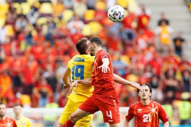 Artem Besedin of Ukraine and Kire Ristevski of North Macedonia battle for the ball during the UEFA Euro 2020 Championship Group C match between...