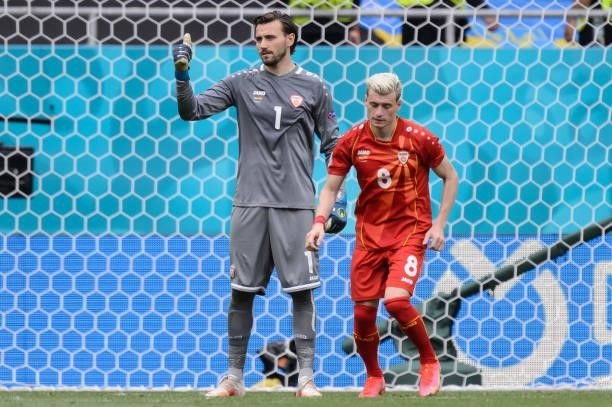 Stole Dimitrievski of North Macedonia and Egzjan Alioski of North Macedonia gestures during the UEFA Euro 2020 Championship Group C match between...